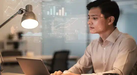 Professional working on a laptop analyzing workplace technology trends
