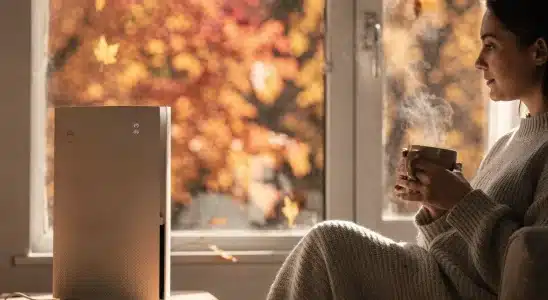 A person relaxing indoors away from fall allergies and outdoor pollen.