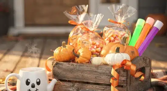 Halloween gift basket filled with festive treats, plush toys, and fall goodies on a porch