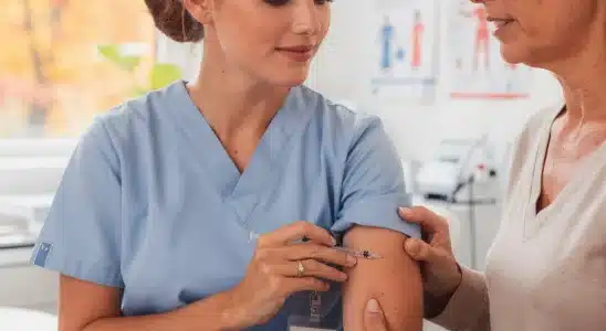 Healthcare worker administering an annual flu vaccine during flu shot season.
