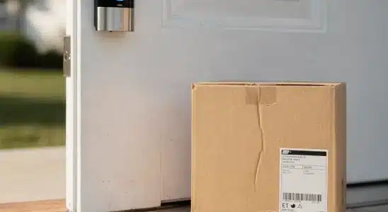 Modern smart video doorbell installed on a home front porch entryway.