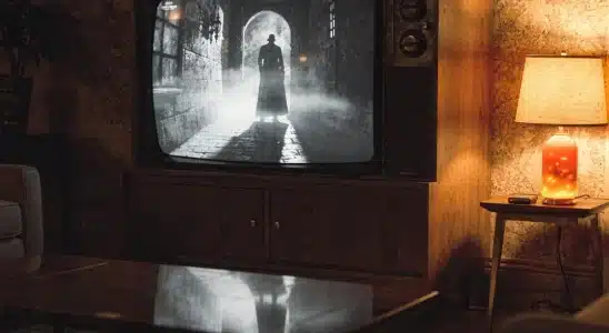 Vintage television displaying a classic horror movie in a moody room
